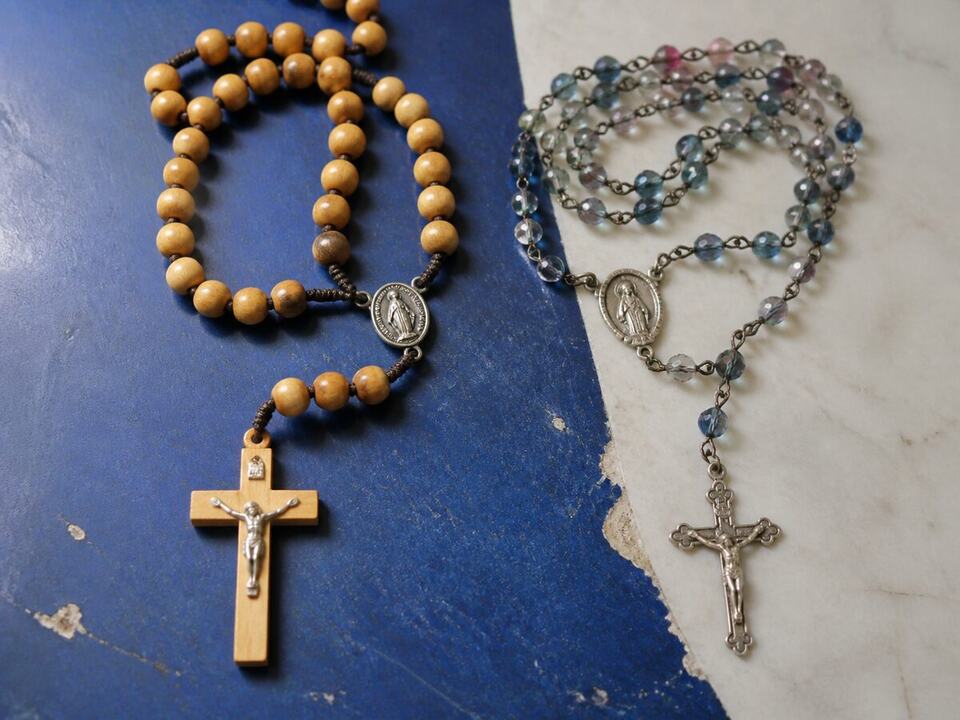 How to choose a rosary: a devotional object arranged on a worktable